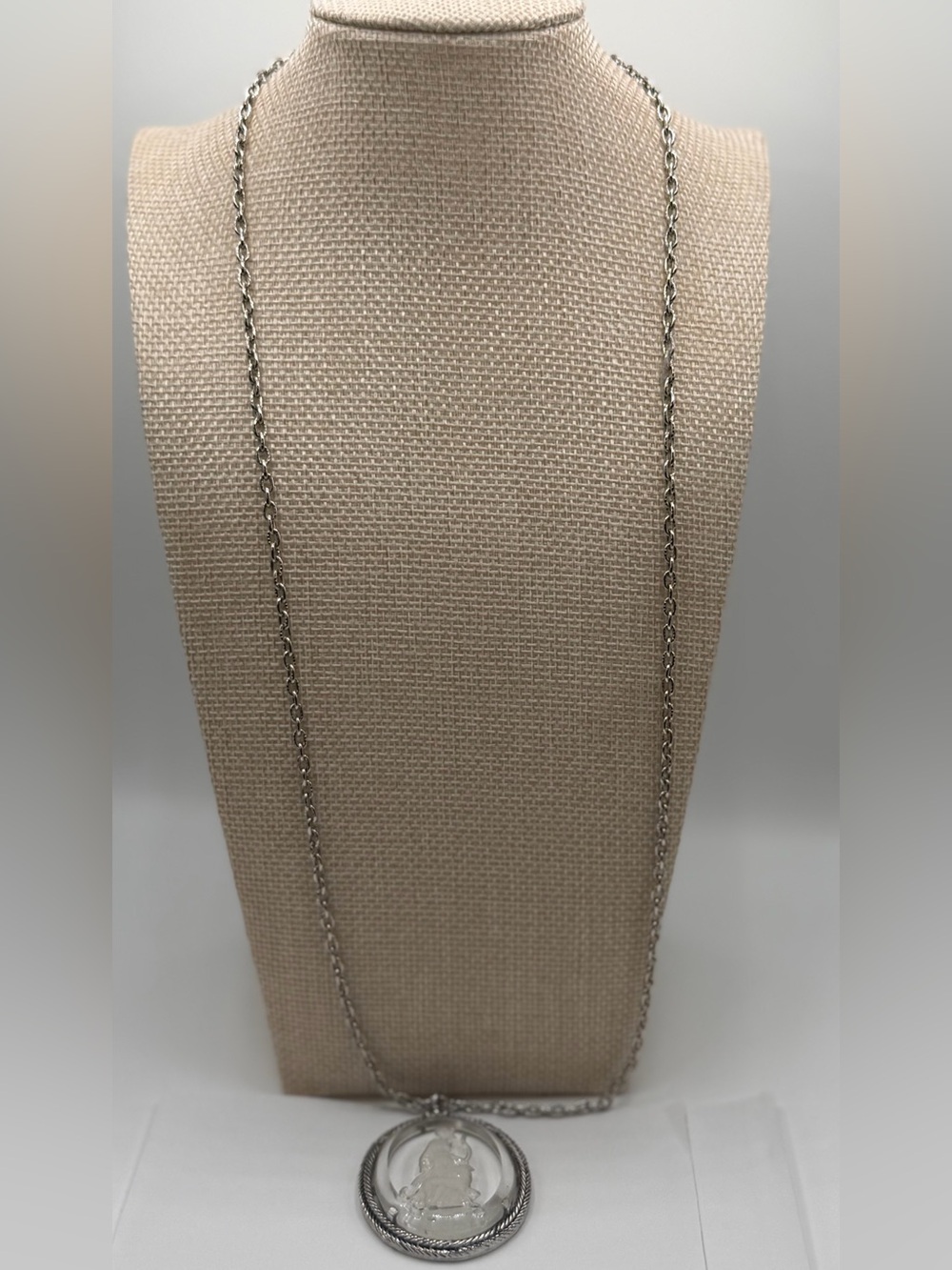 Avon silver long chain with a pendant.